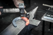 Blacksmith forming a horseshoe