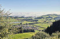 Blick in die Landschaft mit Dorf, einem See, Wiesen und Wälder