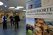 Plakatwand und Besucher im Foyer