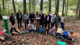 Michaela Kaniber im Wald mit der am Boden sitzenden Ferienspaß-Kindergruppe