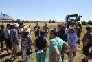 Landwirte diskutieren vor einem Schlepper.