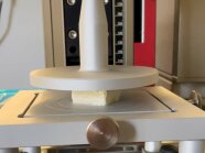 Eine stempelförmige Apparatur prüft Tofu auf Festigkeit.