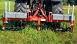 Eine landwirtschaftliche Maschine fährt auf einem Feld. 